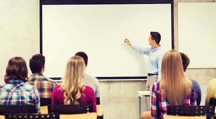 Image showing group of students and smiling teacher in classroom