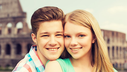 Image showing smiling couple over coliseum background