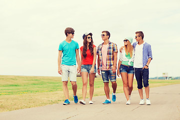 Image showing group of smiling teenagers walking outdoors