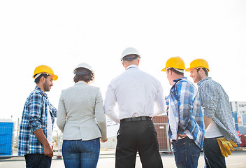 Image showing group of builders and architects at building site