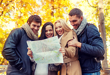 Image showing group of friends with map outdoors