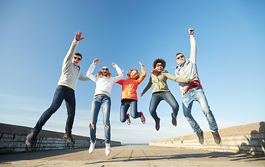 Image showing smiling friends in sunglasses laughing on street