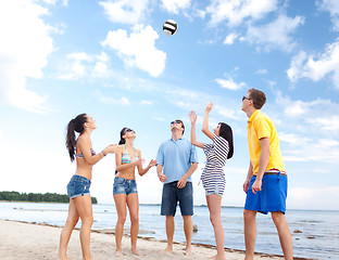 Image showing group of happy friends playing beach ball