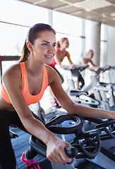 Image showing group of women riding on exercise bike in gym