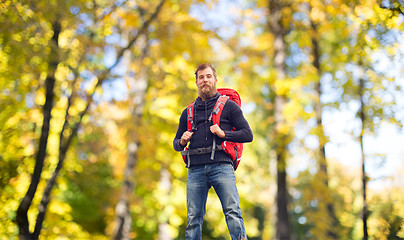 Image showing tourist with beard and backpack raising hands