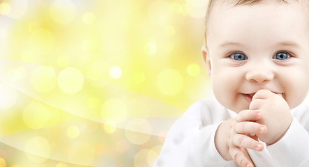 Image showing close up of happy baby over yellow background