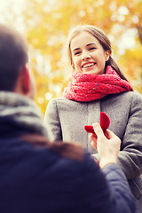 Image showing close up of couple with engagement ring in box