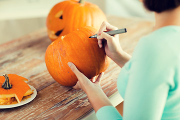 Image showing close up of woman with pumpkins at home