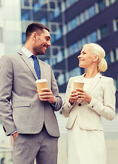 Image showing smiling businessmen with paper cups outdoors