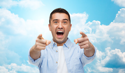 Image showing scared man shouting and pointing finger on you