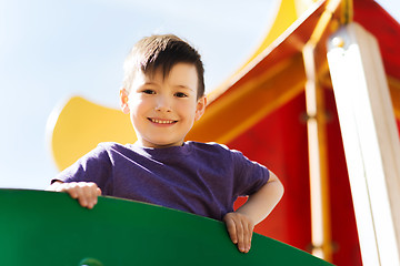 Image showing happy little boy climbing on children playground