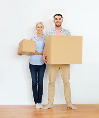 Image showing couple with cardboard boxes moving to new home