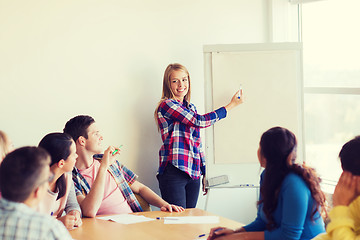 Image showing group of smiling students with white board