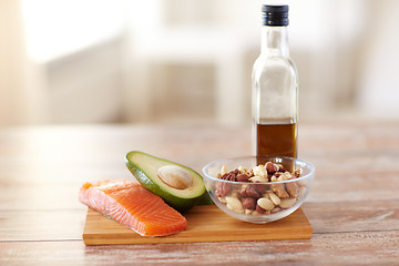 Image showing close up of food and olive oil bottle on table