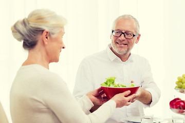 Image showing smiling senior couple having dinner at home