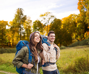 Image showing smiling couple with backpacks hiking