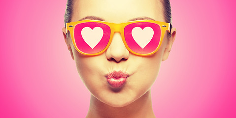 Image showing girl in pink sunglasses blowing kiss