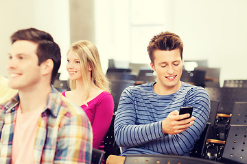 Image showing group of smiling students in lecture hall