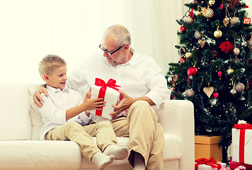 Image showing smiling grandfather and grandson at home