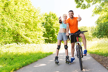 Image showing couple on rollerblades and bike showing thumbs up