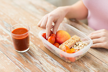 Image showing close up of woman with vegetarian food in box