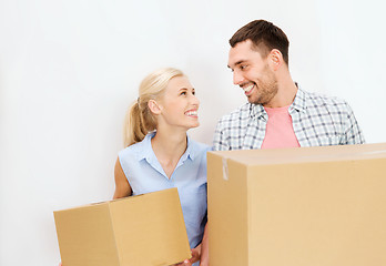 Image showing couple with cardboard boxes moving to new home