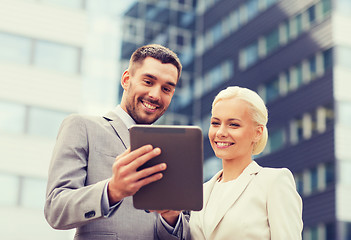 Image showing smiling businessmen with tablet pc outdoors