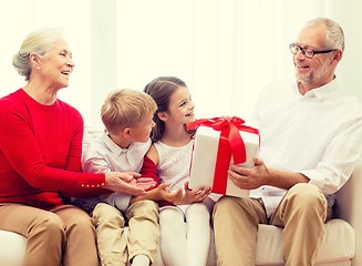 Image showing smiling family with gifts at home