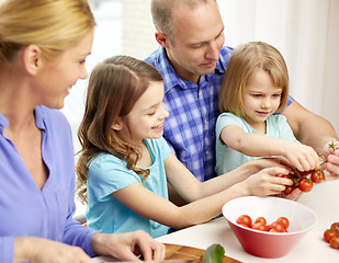 Image showing happy family with two kids cooking at home