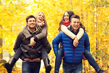 Image showing smiling friends having fun in autumn park
