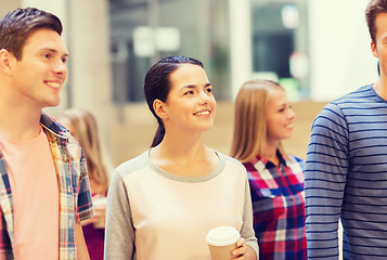 Image showing group of smiling students with paper coffee cups