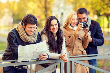 Image showing group of friends with map and camera outdoors