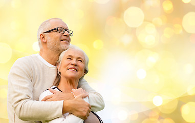 Image showing happy senior couple over holiday lights background