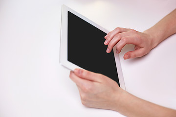 Image showing close up of female hands with tablet pc at table