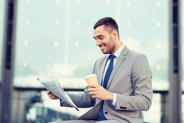 Image showing young businessman with coffee and newspaper