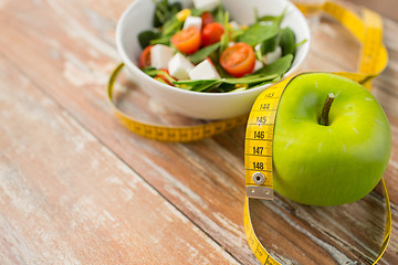 Image showing close up of green apple and measuring tape