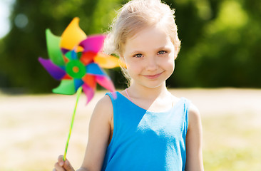 Image showing happy little girl with colorful pinwheel at summer