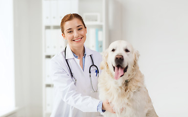 Image showing happy doctor with retriever dog at vet clinic