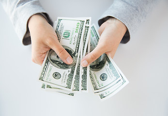 Image showing close up of woman hands counting us dollar money