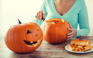 Image showing close up of woman with pumpkins at home