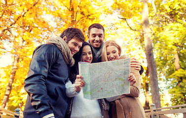 Image showing group of friends with map outdoors