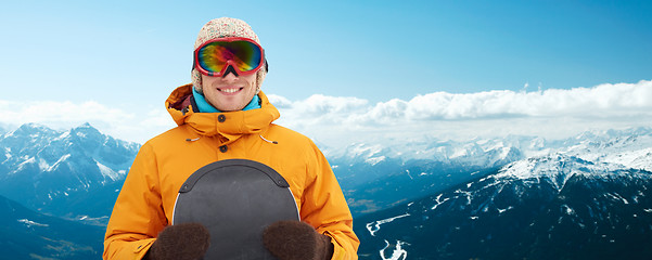 Image showing happy young man in ski goggles over mountains