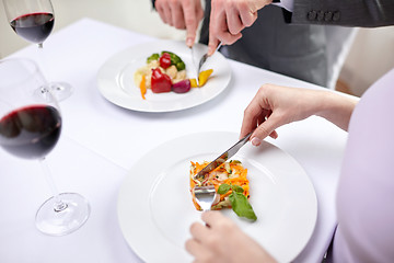 Image showing close up of couple eating appetizers at restaurant