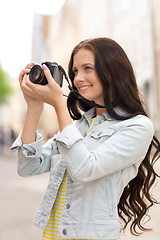 Image showing smiling teenage girl with camera