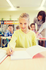 Image showing group of school kids writing test in classroom