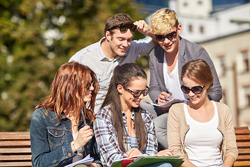 Image showing group of happy students with notebooks at campus