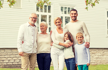 Image showing happy family in front of house outdoors