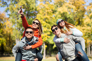 Image showing happy friends in shades having fun at autumn park