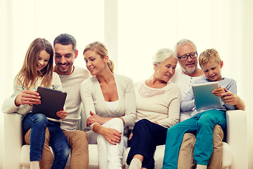 Image showing smiling family with tablet pc at home