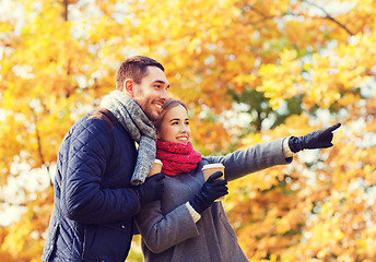 Image showing smiling couple with coffee cups in autumn park